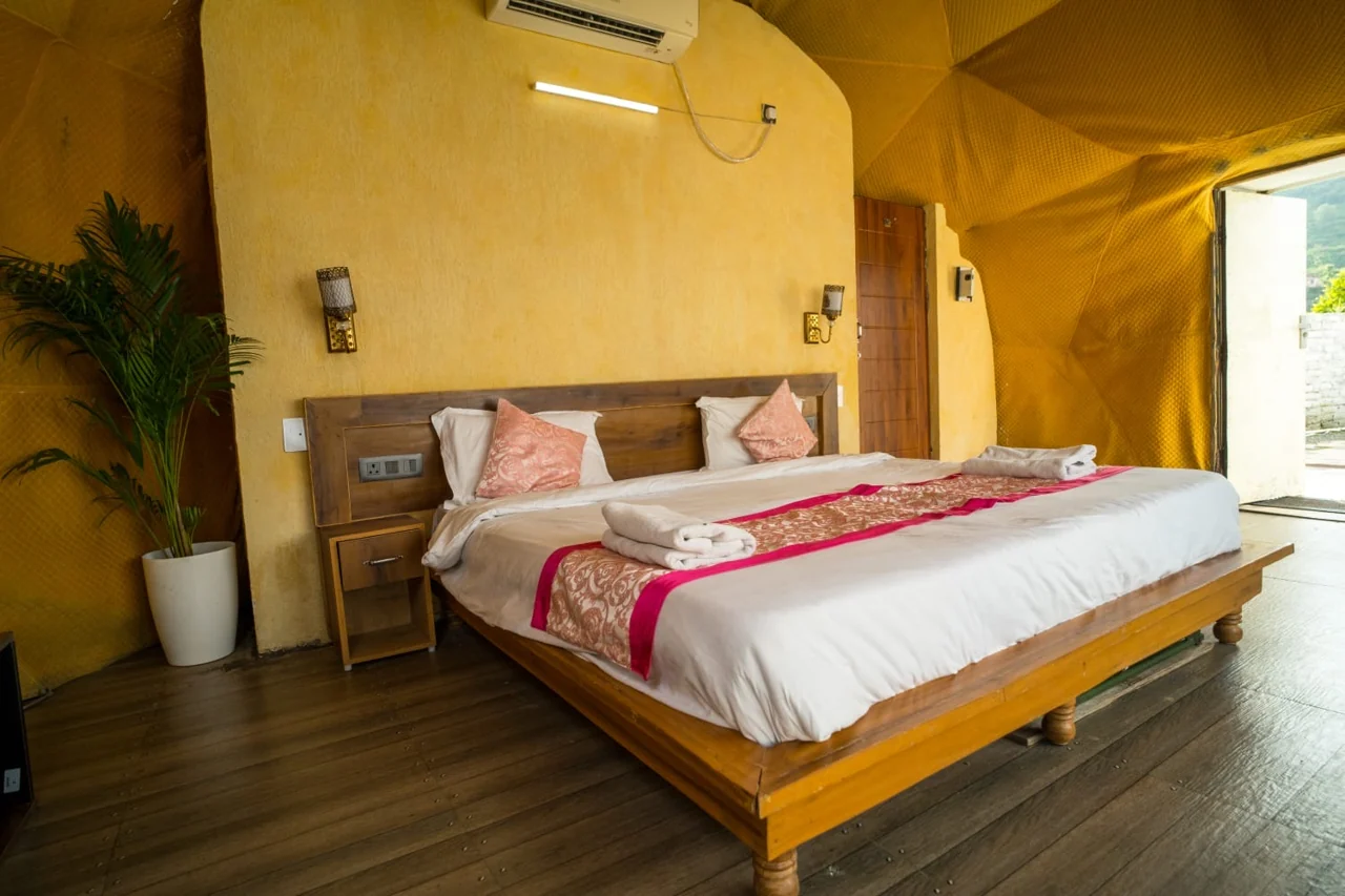 A dome bedroom with warm interiors and a large bed