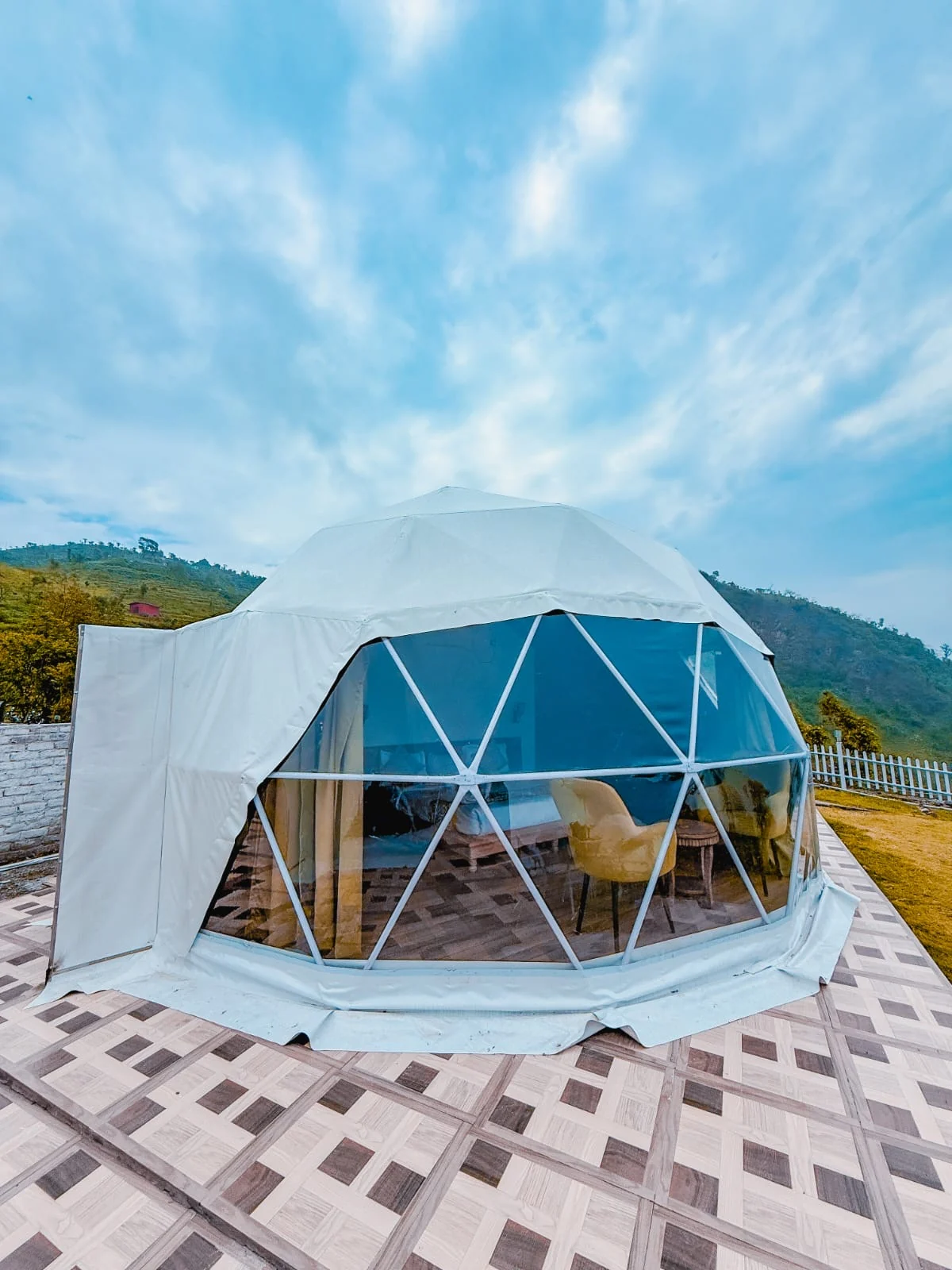 White geodesic dome with a panoramic window at Amantra Hills