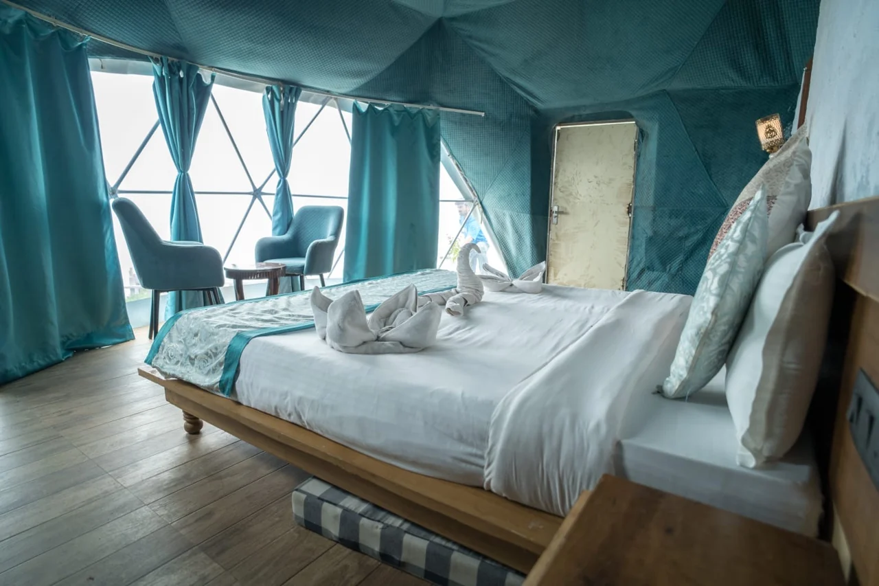 Dome bedroom with large geometric windows and seating