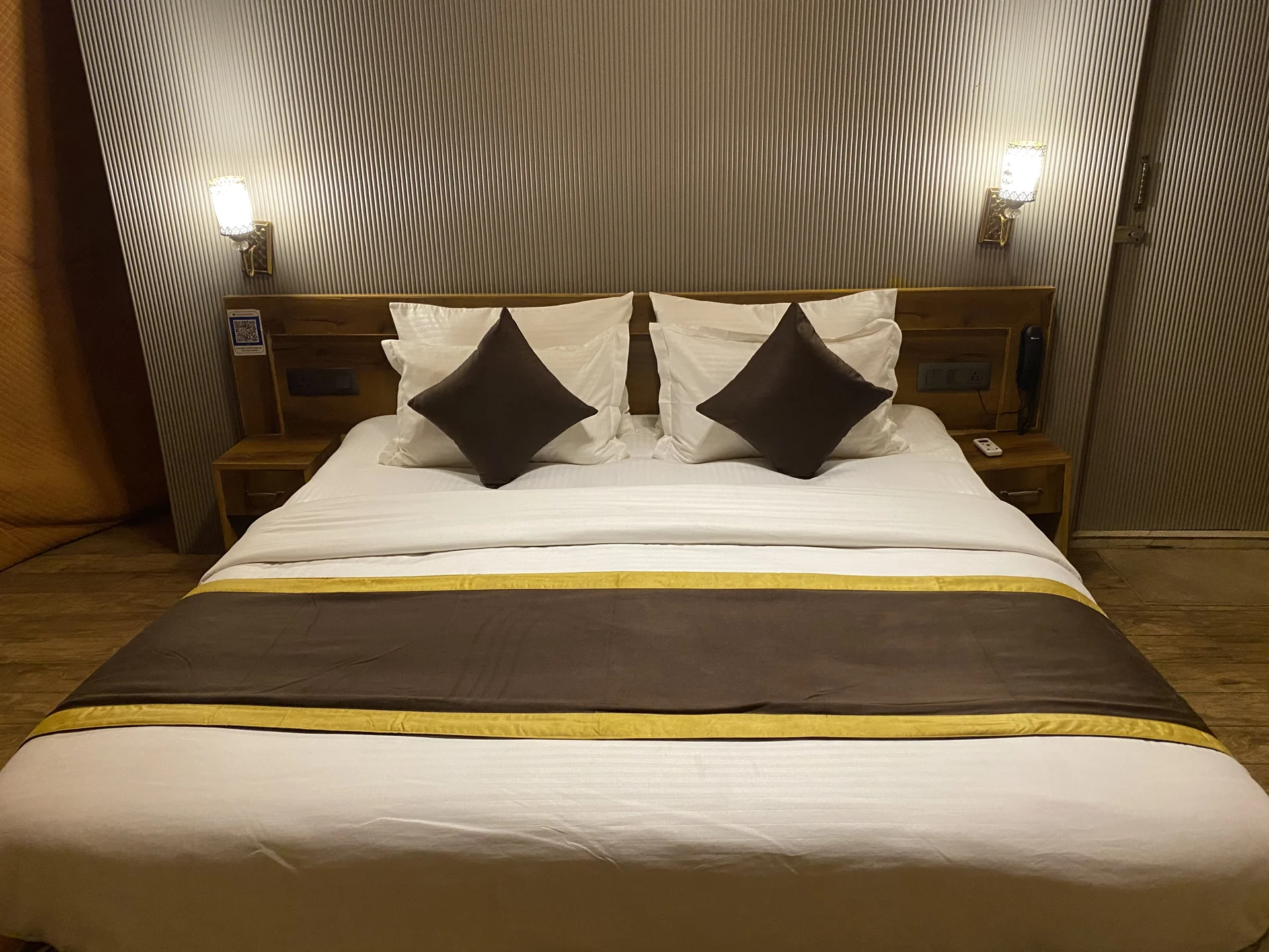 Bed and warm lighting inside the resort accommodation